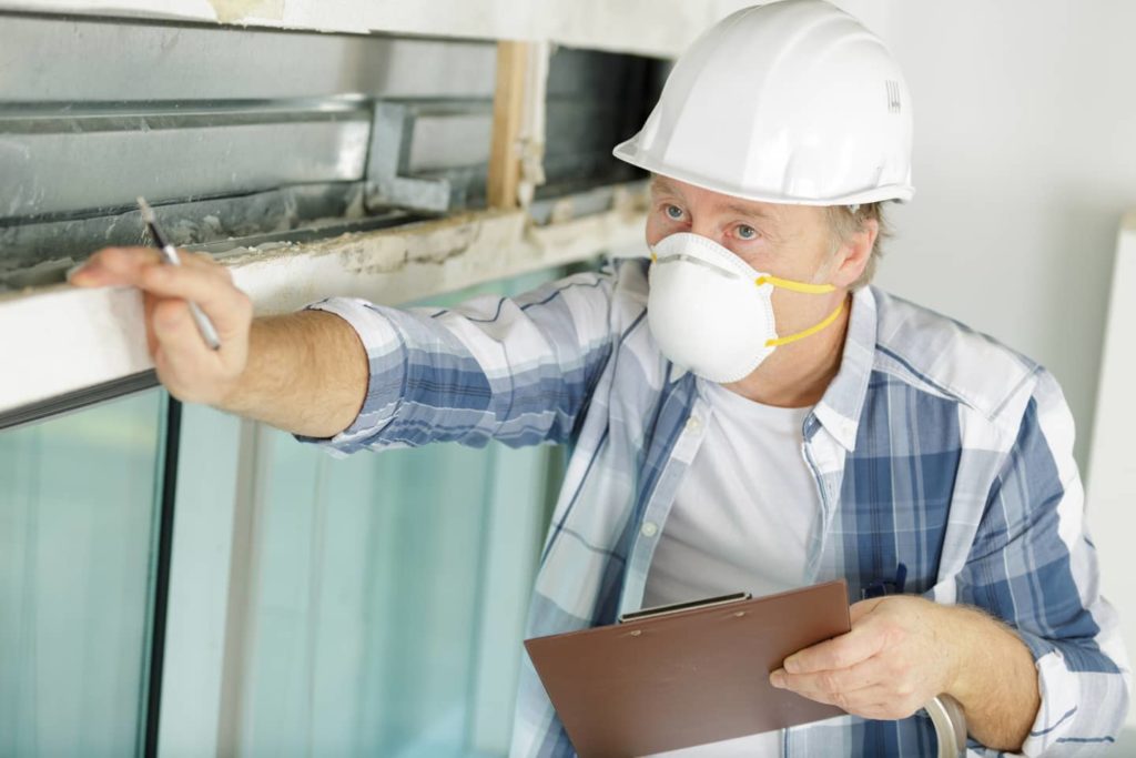 Inspector looking for asbestos material.