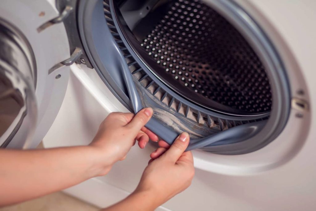 A dirty seal in the front of a washing machine.