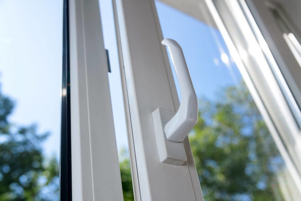 Showing an opened vinyl window with a new look handle.