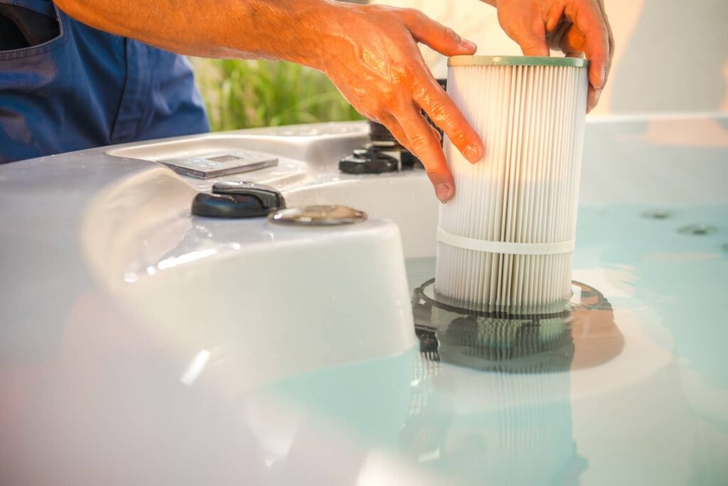 Remove and soak a hot tub filter to clean it out.