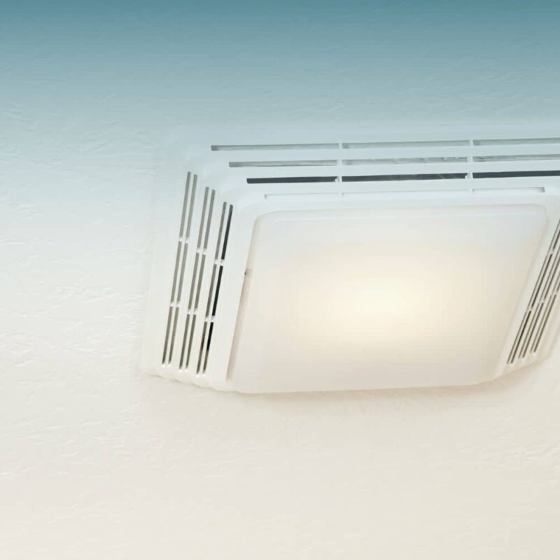 Ceiling-mounted bathroom exhaust fan with a built-in light, installed on a white textured ceiling.