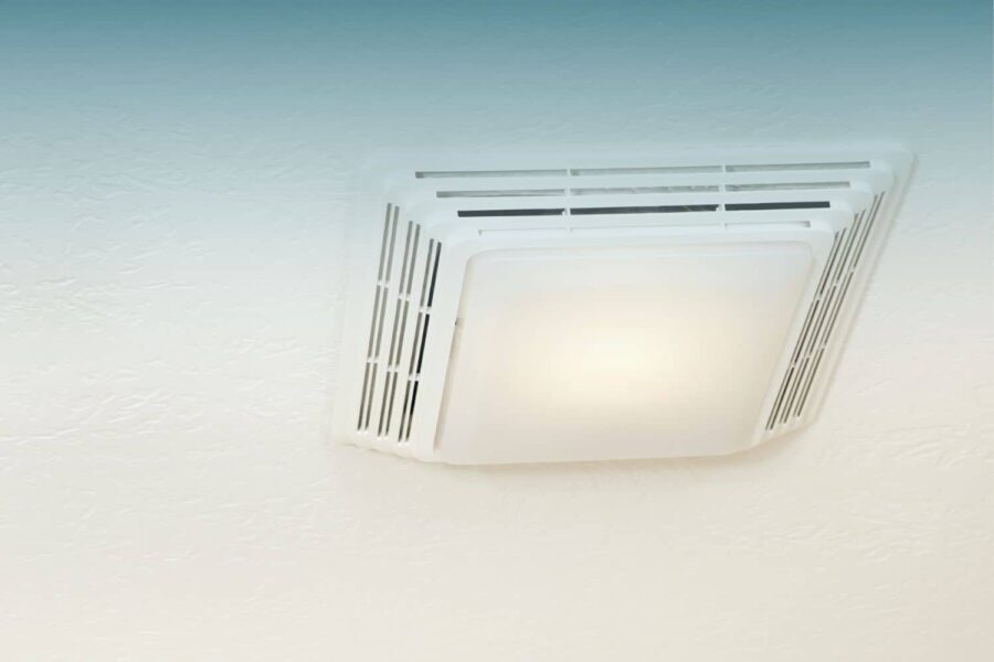 Ceiling-mounted bathroom exhaust fan with a built-in light, installed on a white textured ceiling.