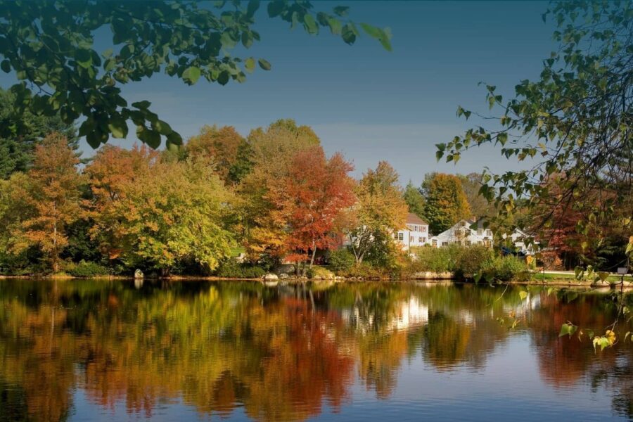New England home exterior with autumn leaves and fall foliage before winter